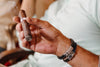 Mature man holding a lit cigar in his hand