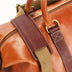 The OpusX Society Italian Leather Duffle Bag Camel and Burgundy Shoulder Guard Closeup